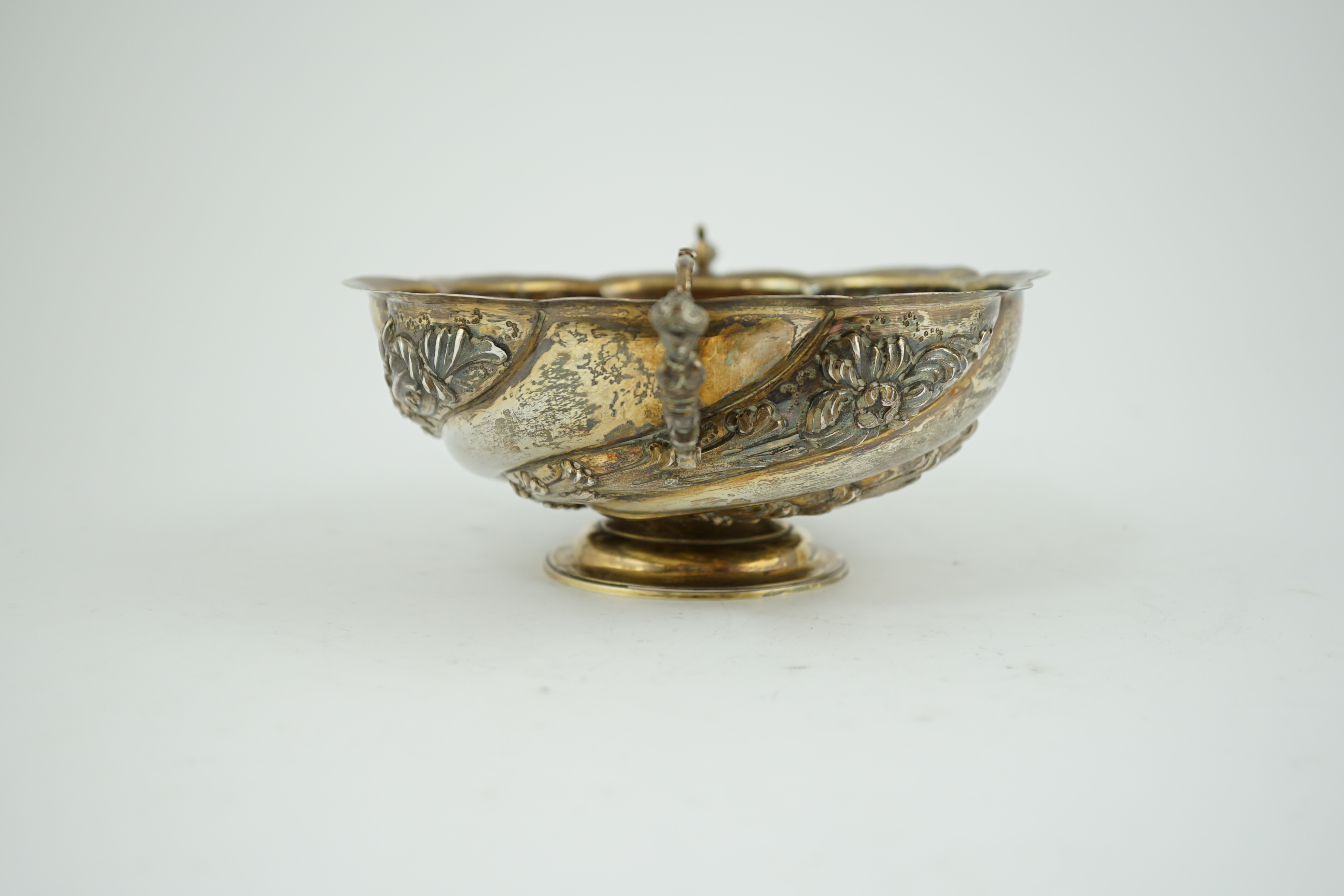 A late Victorian repousse silver two handled fruit bowl, by Charles Stuart Harris